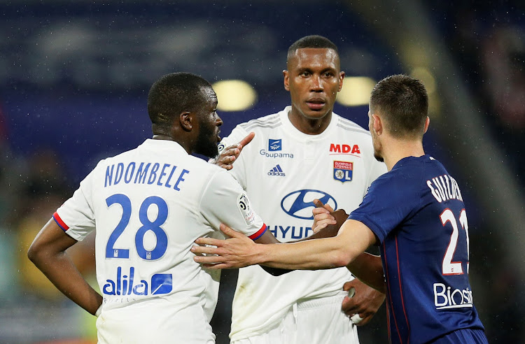 Lyon's Tanguy Ndombele shakes hands with Caen's Frederic Guilbert