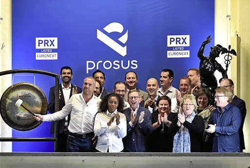 Bob van Dijk, CEO of Naspers and Prosus, strikes the gong at Amsterdam's stock exchange as Prosus began trading on the Euronext on Wednesday.