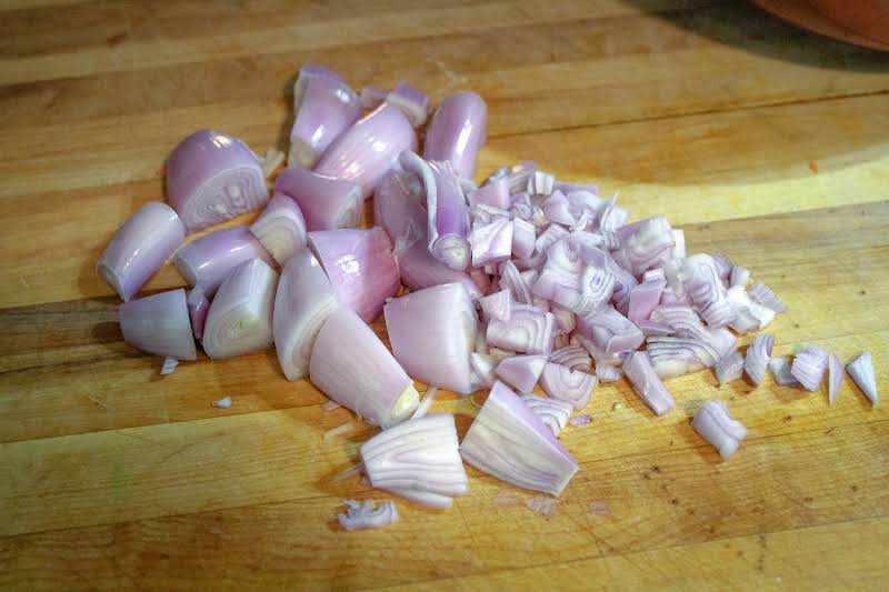 Peeled Shallots Cut In Half And Diced.