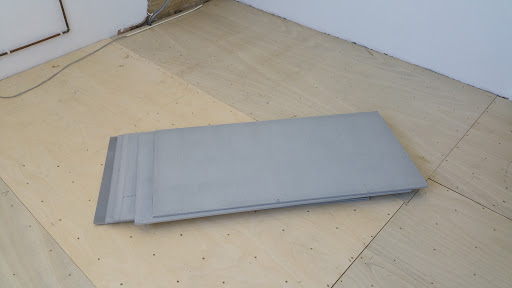 Floor plyboarded with far eastern ply screwed down every 15 cm the warmup up board ready to be stuck down with flexible adhesive