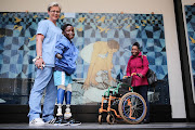 From left: Prosthetist Marissa Nel, George Masiu and his mother Angelina pose for a picture after receiving prosthetic legs at the Johannesburg City Council building in Braamfontein, Johannesburg. Rand Mutual (RMA) donated prosthesis to Masiu as part of the City of Johannesburg’s Disability Awareness campaign. Masiu had his limbs amputated after he contracted a rare degenerative disease.