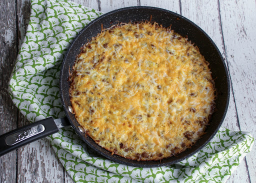 Baked frittata with cheese sprinkled on top.