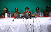 Commander of Zimbabwe Defence Forces General Constantino Chiwenga (C) addresses the media with other security chiefs in Harare, Zimbabwe November 20, 2017.