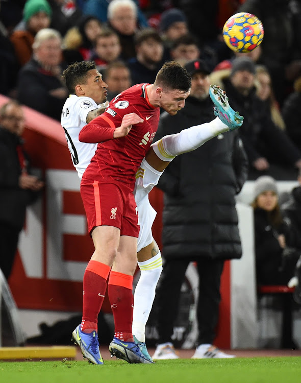 Leeds United's Raphinha in action with Liverpool's Andrew Robertson