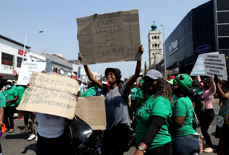 A protester holds up his placard during a protest march in Durban on Monday in opposition to government violating people's freedom of choice