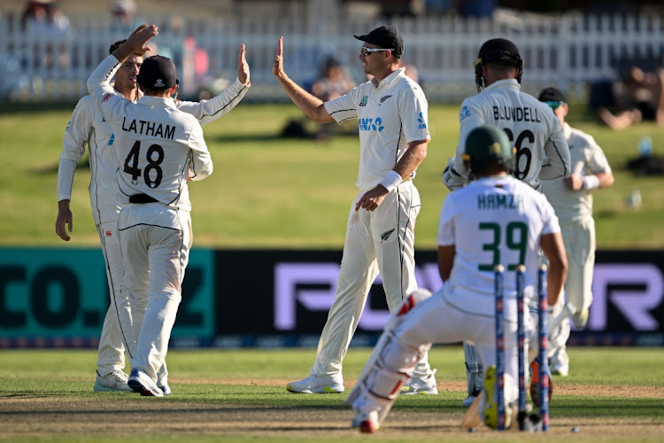 New Zealand players celebrate while Zubayr Hamza curses his misfortune after the ball from Mitchell Santner deflected off the batter’s arm and leg onto his stumps. Picture: JOE ALLISON/GETTY IMAGES