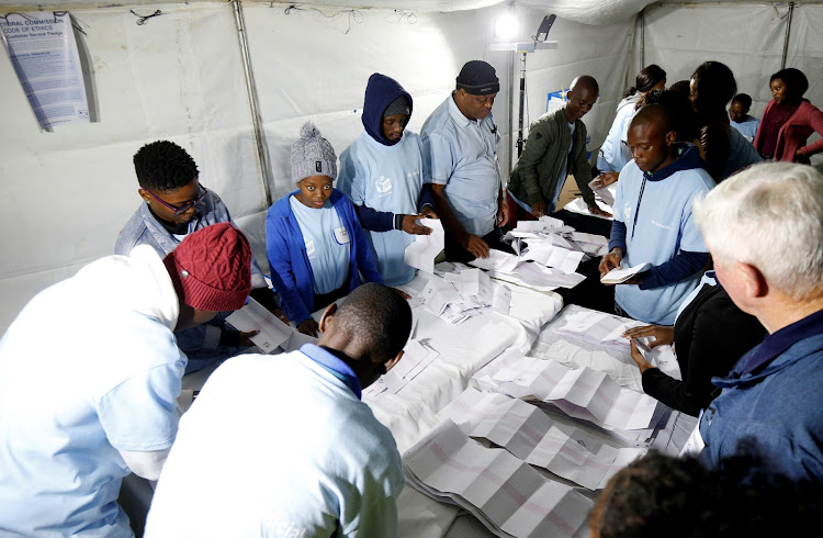 Election officials and observers begin counting votes after stations closed for voting in Assagay near Durban, South Africa, May 8, 2019.