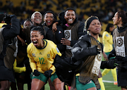 South Africa's Jermaine Seoposenwe celebrates their third goal with teammates scored by Thembi Kgatlana against Italy.