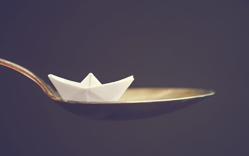 Paper boat and iron spoon