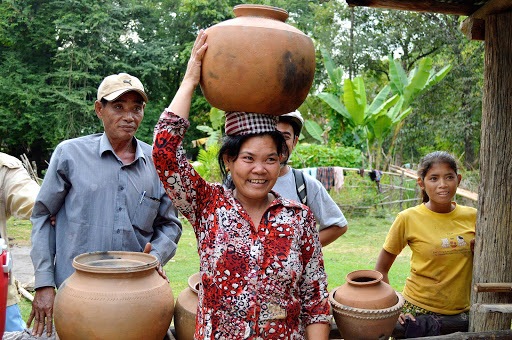 vietnam-woman-carries-pot.jpg - A visit to a local village that was making pottery in the way it had been made for centuries. A very small pot traveled home with us.