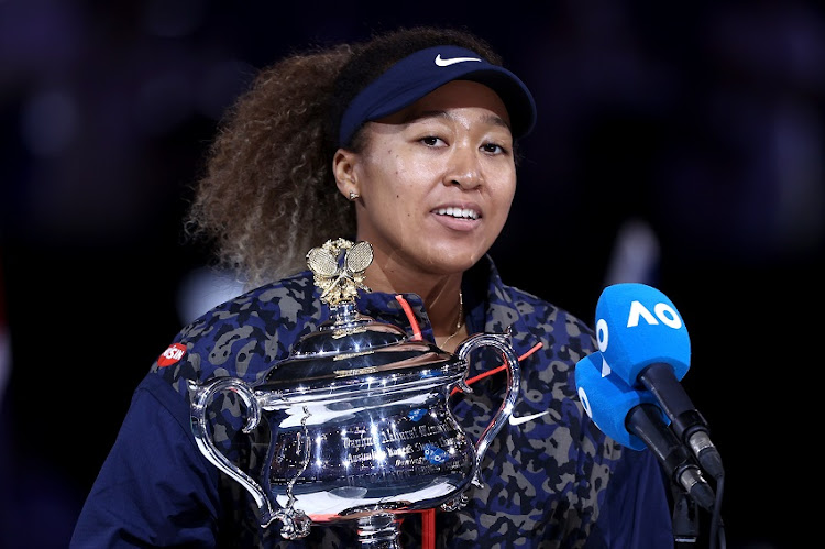 Naomi Osaka of Japan speaks on stage as she holds the Daphne Akhurst Memorial Cup after winning her Women’s Singles Final match against Jennifer Brady of the United States during day 13 of the 2021 Australian Open at Melbourne Park on February 20, 2021 in Melbourne, Australia.