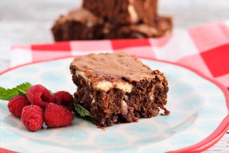 Raspberry Cream Cheese Brownie On A Plate.