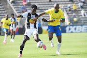 Mamelodi Sundowns' Mosa Lebusa challenges File Traore of TP Mazembe in their 2023-24 Caf Champions League group stage match at Lucas Moripe Stadium on March 2.