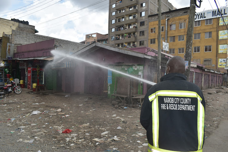 A city county official fumigates stalls in Eastleigh on Saturday, April, April 18