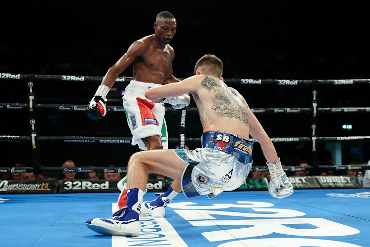 Zolani Tete knocks down Jason Cunningham during the IBF International and Commonwealth Super Bantamweight title fight at OVO Arena Wembley on July 2 2022 in London.