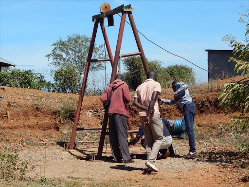 Miners look at Sindule mines on Tuesday where two people died