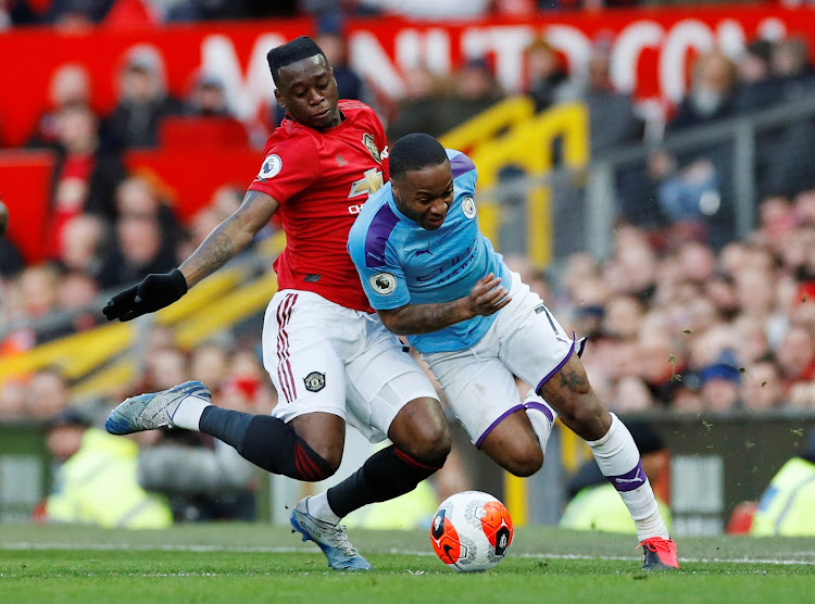 Manchester City's Raheem Sterling vies for the ball with Manchester United's Aaron Wan-Bissaka