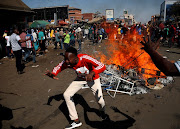 Supporters of the opposition Movement for Democratic Change party (MDC) of Nelson Chamisa react as they block a street in Harare, Zimbabwe, August 1, 2018.  