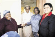 ELATED: Jabu Nxumalo, left, MaKhumalo Zuma, Sbongile Nxumalo and KZN MEC for human settlements Maggie Govender during the official handing over of a house. Pic: THULI DLAMINI. 19/07/2009. © Sowetan.