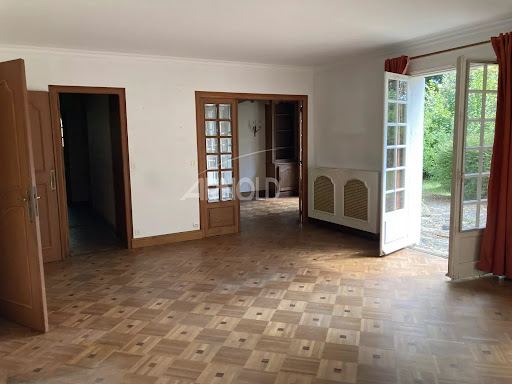 Living room with parquet floor and glass doors in this luxury property for sale in Vannes ($868,387 - 200 m²)