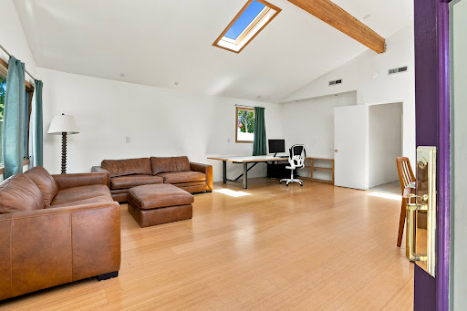 Living room with leather sofas and desk in this luxury property for sale in Los Gatos ($2,358,000)