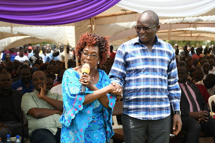 DG Arthur Odera shakes hands with the wife of Teso North MP Oku Kaunya during the burial on October 14, 2022 at Korisai village in Teso North.