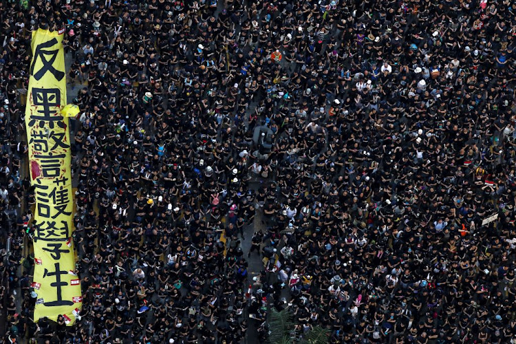 Protesters hold placards as they attend a demonstration demanding Hong Kong's leaders step down and withdraw the extradition bill, in Hong Kong, China, on June 16 2019.