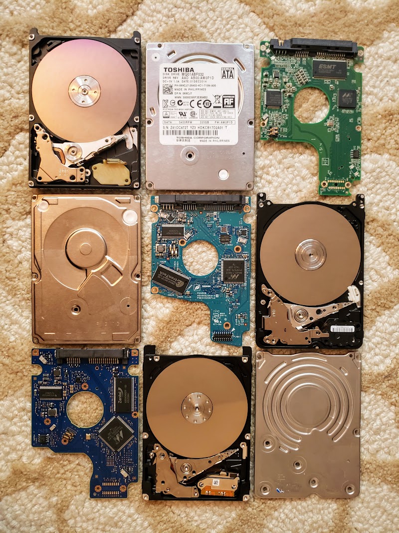 Three disassembled hard drives arranged in a 3x3 grid