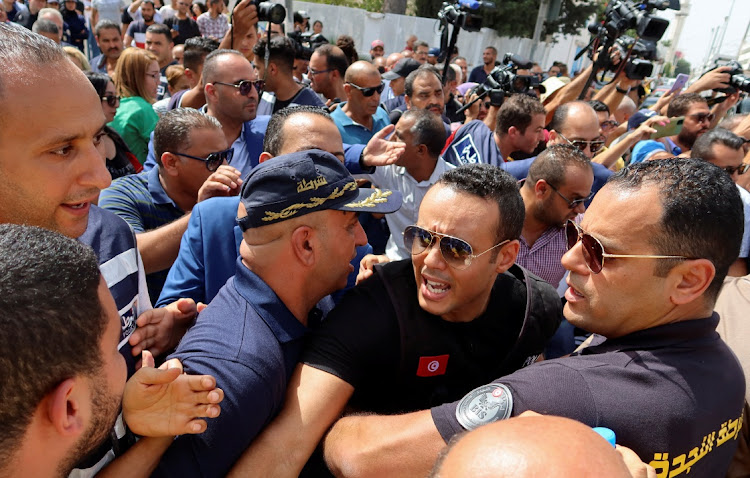 Police members push back supporters of Tunisia's Islamist opposition party Ennahda protesting in support of the party leaders, Rached Ghannouchi and Ali Larayedh, who are facing questioning by anti-terrorism police in Tunis,Tunisia September 19, 2022.