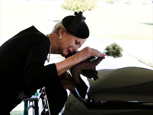 Cindy McCain lays her head on the casket of Sen. John McCain, during a burial service at the cemetery at the United States Naval Academy in Annapolis, Md., on Sunday, September 2, 2018. /REUTERS