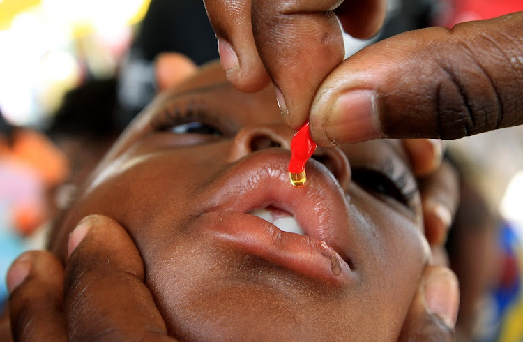 A child receives vitamins during a vaccination campaign against polio organised by UNICEF. File photo.