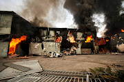 Burning factory in Sea Cow Lake area on July 12, 2021 in Durban, South Africa. It is reported that a considerable number of shops and businesses  were looted over the weekend following a wave of violent protests after the incarceration of former South African President Jacob Zuma.  