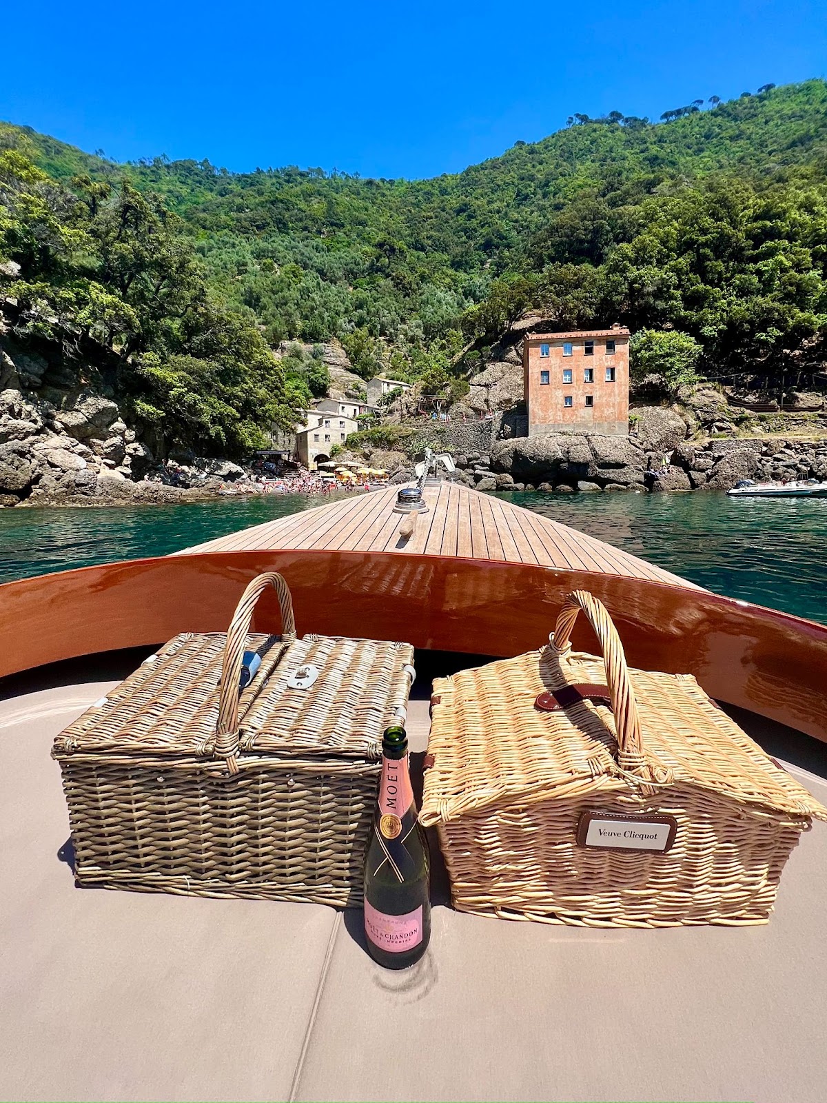 a boat with picnic baskets and a bottle of champagne on the front