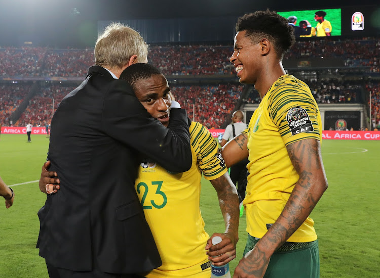 South Africa head coach Stuart Baxter celebrates with goalscorer Thembinkosi Lorch and midfielder Bongani Zungu after Bafana Bafana beat host nation Egypt 1-0 to book a place at the Africa Cup of Nations quarterfinals against Nigeria on Wednesday July 10 2019.