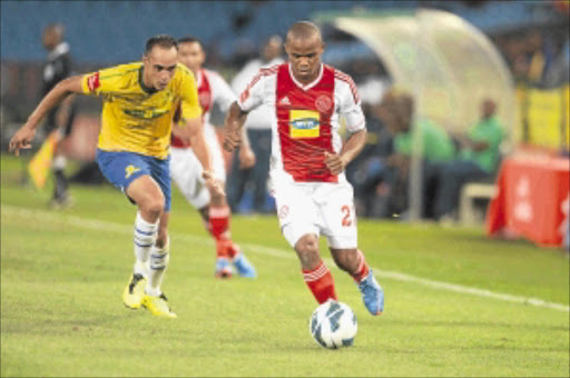 EYES ON THE BALL: Eleazer Rodgers of Mamelodi Sundowns, left, and Cecil Lolo of Ajax Cape Town during their Absa Premiership match at Loftus Stadium in Pretoria last night. Photo: Gallo Images