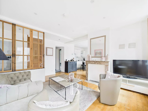 Living room with fireplace and decorative window in this luxury apartment / penthouse for sale in La Madeleine ($398,962 - 71 m²)