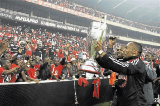 VICTORY: Katlego Mashego holds the Premiership trophy aloft after Pirates won the league in the final against Golden Arrows last year. Photo: Gallo Images