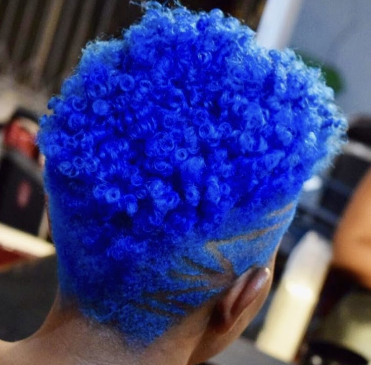 Image of a girl with blue dyed hair and a cut