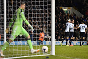 Tottenham Hotspur's Icelandic midfielder Gylfi Sigurdsson (2R) celebrates scoring Tottenham's fifth goal as Sunderland's Italian goalkeeper Vito Mannone (L) retrieves the ball during the English Premier League football match between Tottenham Hotspur and Sunderland at White Hart Lane in north London on April 7, 2014. Tottenham won 5-1.