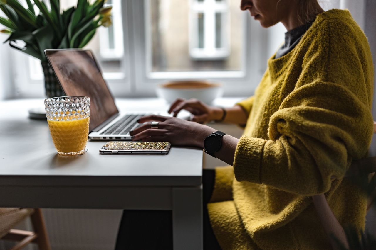 business woman working on her laptop to boost her confidence as a business owner