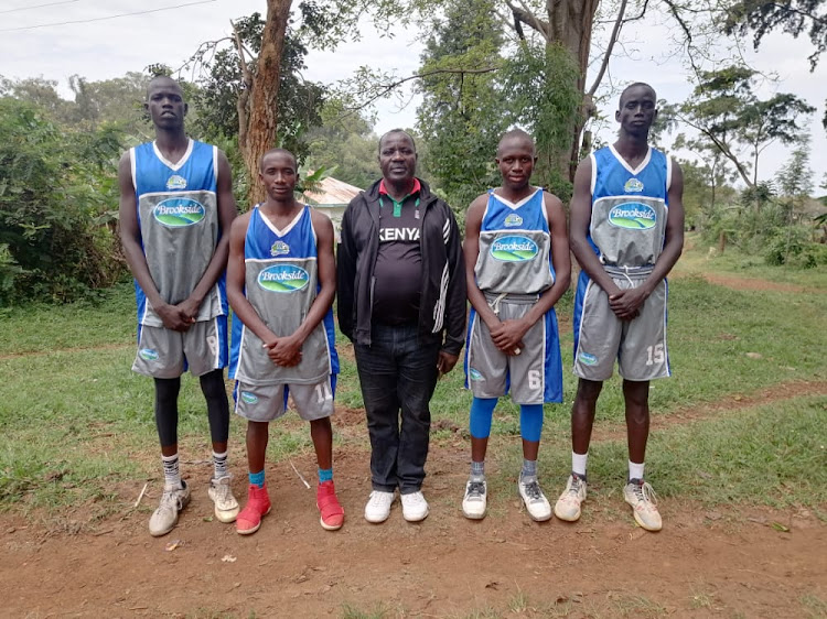 Onjiko High School coach and principal Joseph Were with some of his players