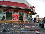 Broken glass, smashed windows at a looted shop in Mitchells Plain on Tuesday. 