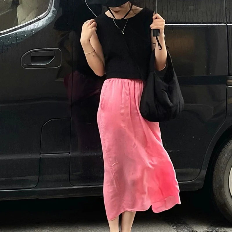 Falda línea A de largo medio con cintura elástica, abertura trasera y color sólido. Ideal para un look versátil y cómodo.