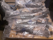 The police found two R4 rifles, four R5 rifles, a revolver, a minibus and a sedan.