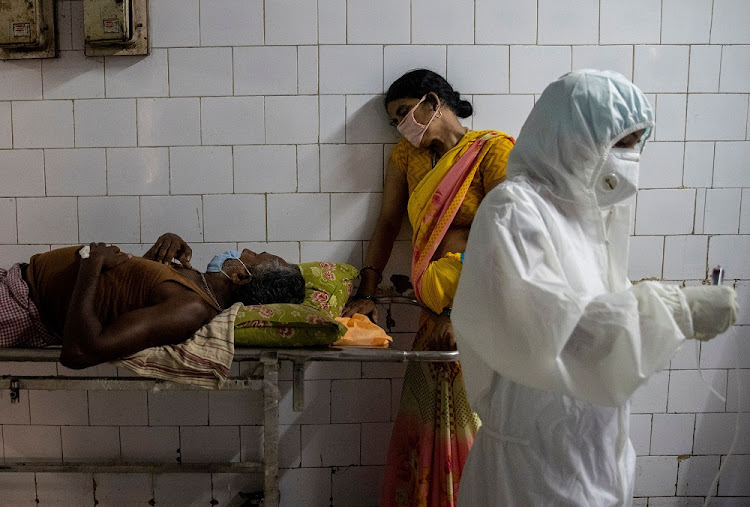 A woman leans against a stretcher holding her husband in the corridor of the emergency ward of Jawahar Lal Nehru Medical College and Hospital, during the coronavirus disease (COVID-19) outbreak, in Bhagalpur, in the eastern state of Bihar, India, July 27 2020.