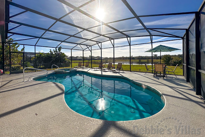 Sun-drenched south-facing pool deck with gorgeous lake view at this Watersong vacation villa