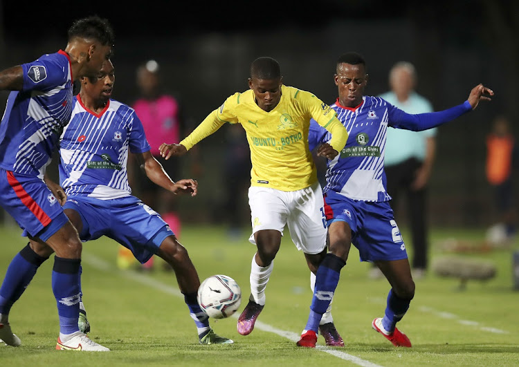 Neo Maema of Mamelodi Sundowns is challenged by Nichlus Lukhubeni, Genino Palace and Clayton Daniels of Maritzburg United in the DStv Premiership match at Harry Gwala Stadium Stadium in Petermaritzburg on March 5 2022.