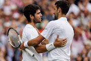 Carlos Alcaraz of Spain embraces Novak Djokovic of Serbia after defeating him in the final of the men's singles of The Championships Wimbledon 2023 at the All England Lawn Tennis and Croquet Club in London on July 16 2023. 