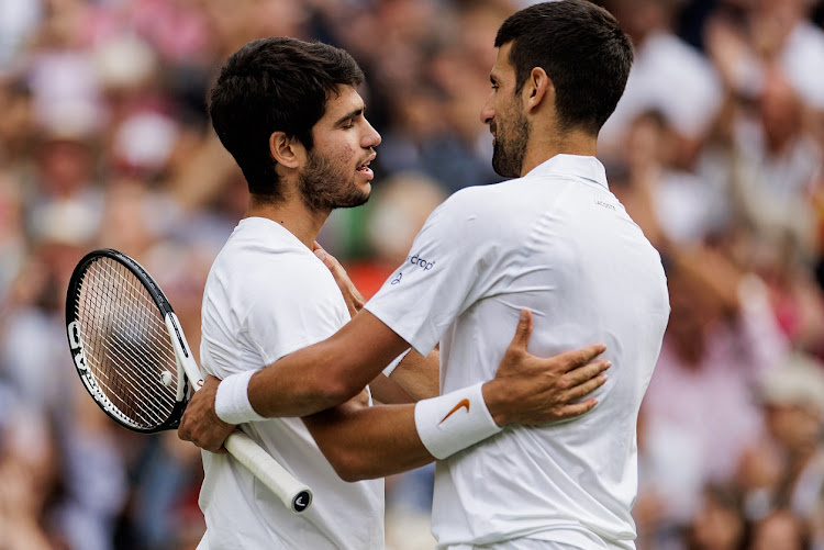 Carlos Alcaraz of Spain embraces Novak Djokovic of Serbia after defeating him in the final of the men's singles of The Championships Wimbledon 2023 at the All England Lawn Tennis and Croquet Club in London on July 16 2023.