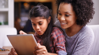 Mother looking at a tablet with her child